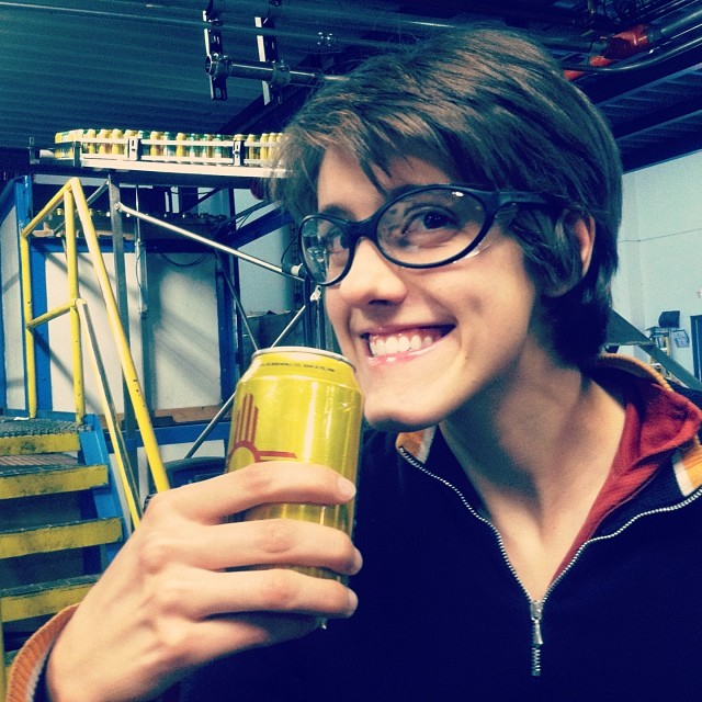 Smiles and safety glasses --here I am with my Happy Camper IPA straight off the canning line! 